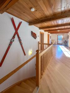 a room with a staircase with a large cross on the wall at TIROLER TRAUMHAUS Hochzillertalblick - AlpenLuxus Collection in Stumm