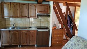a kitchen with wooden cabinets and a staircase at Sorgente dell'Aniene in Filettino