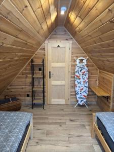 a room with two beds and a door at Domki na granicy in Jeżowski Dział