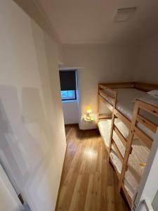 a small room with two bunk beds and a window at Cantinho das Portas do Sol in Lisbon