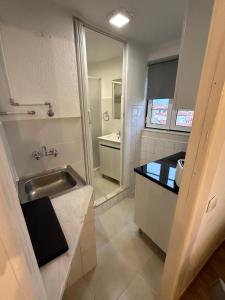 a small bathroom with a sink and a mirror at Cantinho das Portas do Sol in Lisbon +22 photos