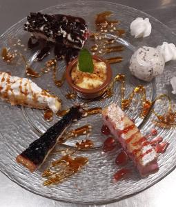 a plate with different types of desserts on it at Hotel De La Poste in Saint-Martin-sous-Vigouroux