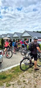 a group of people riding bikes in a parking lot at Domki Apartamentowe Rozgwiazdy 20 in Jarosławiec
