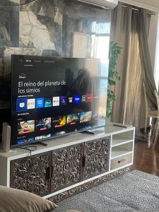 a large flat screen tv sitting on a entertainment center at Altea Beach in Altea