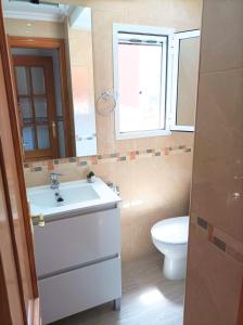 a bathroom with a sink and a toilet at El Cabanyal 400m from the Beach in Valencia