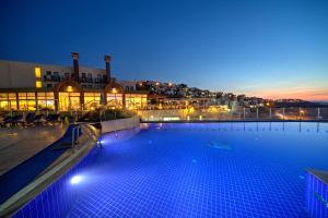 a large swimming pool in a building at night at Crystal Hotel Bodrum in Gumusluk