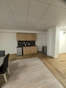 an empty room with a kitchen and a table at Apartament Bellisimo in Sofia