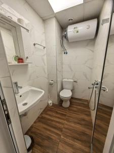 a bathroom with a toilet and a sink at Apartament Bellisimo in Sofia