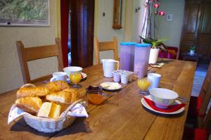 a wooden table with a basket of bread and eggs at Gîte Mont Joly in Saint-Gervais-les-Bains