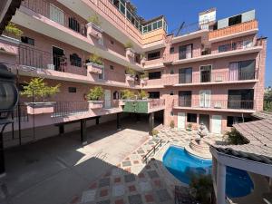 an apartment building with a pool in front of it at hotel brisas del pacifico in Puerto Vallarta +12 photos