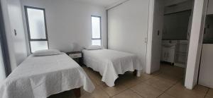 Giường trong phòng chung tại Apart Hotel Azimut Iquique