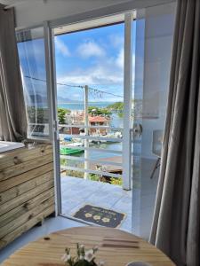 a room with a door open to a balcony at Apartamento Rio da Barra in Florianópolis