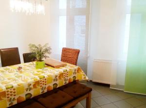 a dining room table with a yellow and white table cloth at Ferienwohnung am Nürburgring in Adenau