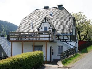 a large white house with a gambrel roof at Ferienhaus in Willingen mit eigenem Garten in Willingen