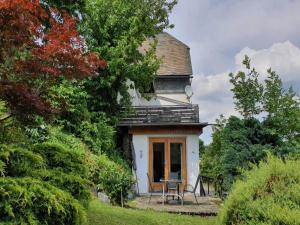 a small white house with a table and chairs at Ferienhaus in Willingen mit eigenem Garten in Willingen +23 photos