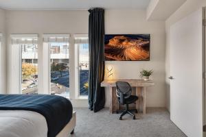 a bedroom with a desk and a bed and a window at Gorgeous 2BD 2BA Pool,Gym,Htub near Convention Ctr in Salt Lake City