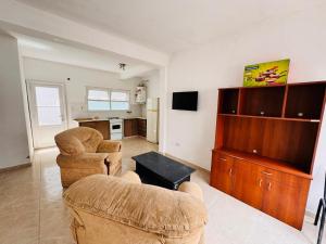 a living room with two couches and a kitchen at propiedades cerca de Güemes y playa grande in Mar del Plata