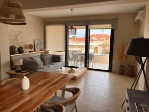 a living room with a table and a couch at Izla Apartment in Skala