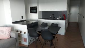 a kitchen with a table and chairs in a room at Falcon in Middelkerke +3 photos