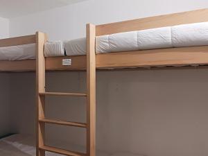 a bunk bed with a ladder on the bottom bunk at Résidence Pierre Blanche - Très agréable deux pièces cabine idéalement situé en centre station au pied des remontées mécaniques MAE-7744 in Arc 1600