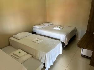 Giường trong phòng chung tại Chácara 2 coracoes