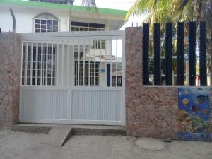 a white gate in front of a house at Posada for Living in San Andrés