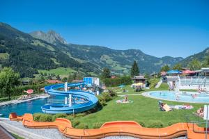 a resort with a water park with a water slide at Chalet Franzi - gleich an der Piste im Gasteinertal in Dorfgastein