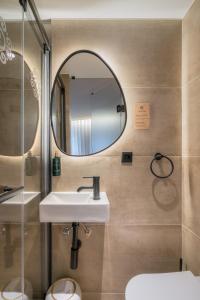 a bathroom with a sink and a mirror at Carpe Diem Porto By Dualhotels in Porto +36 photos