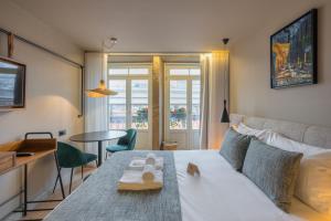 a hotel room with a bed and a table with a tray on it at Carpe Diem Porto By Dualhotels in Porto