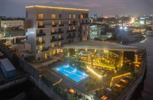 a hotel with a swimming pool at night at The Bickley Park Hotel in Lekki Phase 1