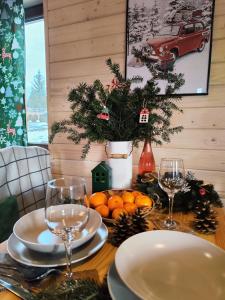 un tavolo con due bicchieri di vino e arance sopra di Leśna Przystań - Domki całoroczne a Grywałd