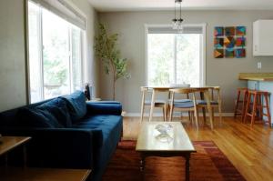a living room with a blue couch and a table at Spacious 4bed, super close to UM & Downtown, 2 living rooms in Missoula