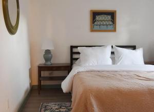 a bedroom with a bed with white pillows and a mirror at Spacious 4bed, super close to UM & Downtown, 2 living rooms in Missoula