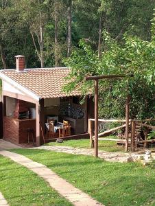 a house with a pavilion in a yard at Pousada Turmalina in Bueno Brandão