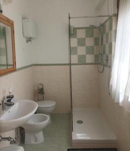 a bathroom with a sink and a toilet and a shower at Affitta camere Via Piave in Foligno