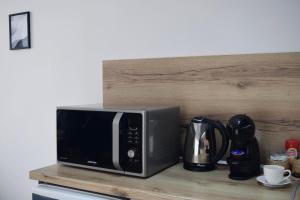 a microwave sitting on top of a wooden shelf at Orpheus and Eurydice in Smolyan