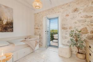 a bedroom with a bed and a door to a balcony at Villa pero -an artists home in Ždrelac +74 photos