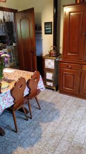 a kitchen with a wooden table and a table and chairs at Casa Sala in Castionetto di Chiuro +18 photos