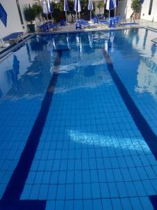 a large swimming pool with blue tiles on it at George Studios Stalis in Stalís