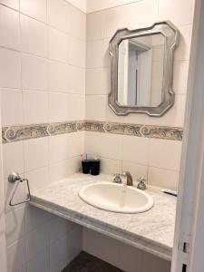 a bathroom with a sink and a mirror at Estancia El Sosiego in Gualeguay +103 photos