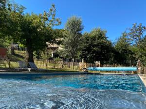 a swimming pool with blue water in a yard at Mas Mialou in Saint-Jean-du-Gard