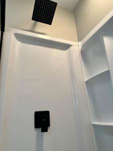 a refrigerator with a speaker on the wall at MidWay Mountain Views in Asheville