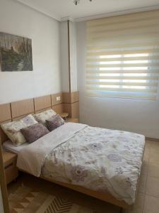 a bedroom with a large bed with a window at Torremar - Magic World - Marina d'or in El Borseral