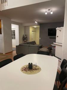 a living room with a white table and a couch at Hiihtäjänkuja 5A4, Levi in Levi