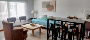 a living room with a bed and a table and chairs at La Morada Apart in Cafayate