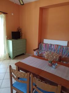 a living room with a table and a couch at Vegera Apartment M in Vasilikiádhes