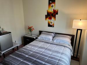 a bedroom with a bed and a tv at Have a comfortable stay! in San Jose
