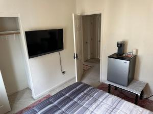 a bedroom with a bed and a flat screen tv at Have a comfortable stay! in San Jose