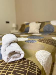 a bed with a towel laying on top of it at Studio Moderne avec terrasse in Er Rachidia