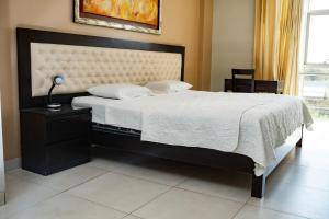 Ένα ή περισσότερα κρεβάτια σε δωμάτιο στο Cacique Hotel